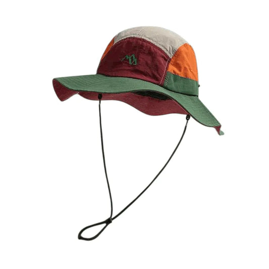Chapéu Bucket Explorer Shield em design color block (verde, laranja, bege), acessório de Alto Valor com proteção solar.