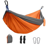Rede Casal Camping laranja e cinza com kit completo (fivelas e cordas de nylon), destacando as fivelas de alpinismo de Alto Valor.